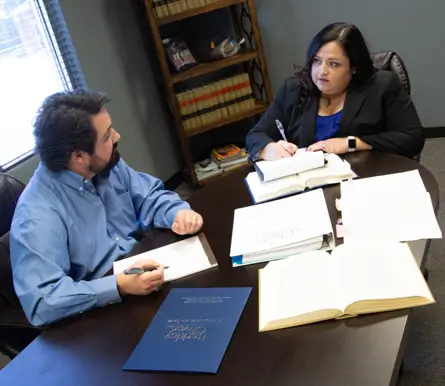 Attorneys of Berkley and Oliver working and discussing a probate client.