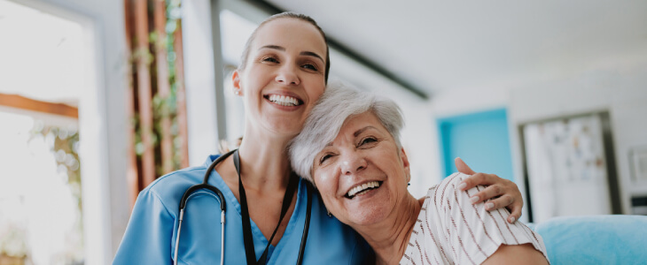 Elderly woman smiling with healthcare provider