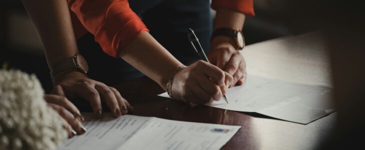 people signing paperwork for estate administration